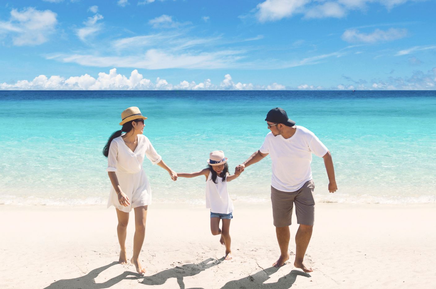 Family on a white sand beach central